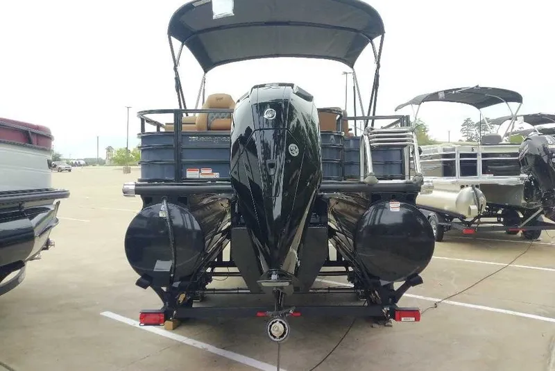 Slide: The Image of 2027 Ranger 223FC pontoon boat with outboard motor, parked in a lot. - 11