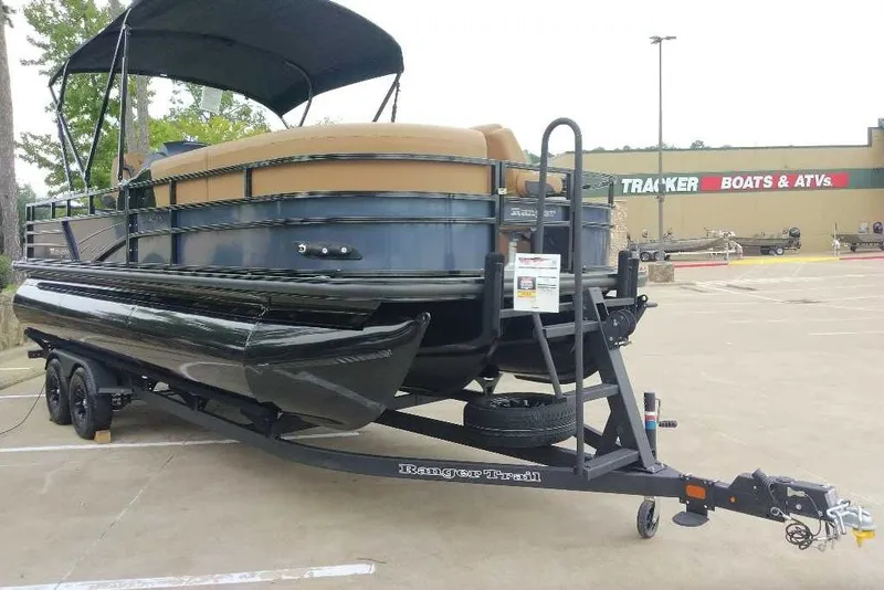Slide: The Image of 2027 Ranger 223FC pontoon boat on trailer at dealership, featuring sleek black design. - 13
