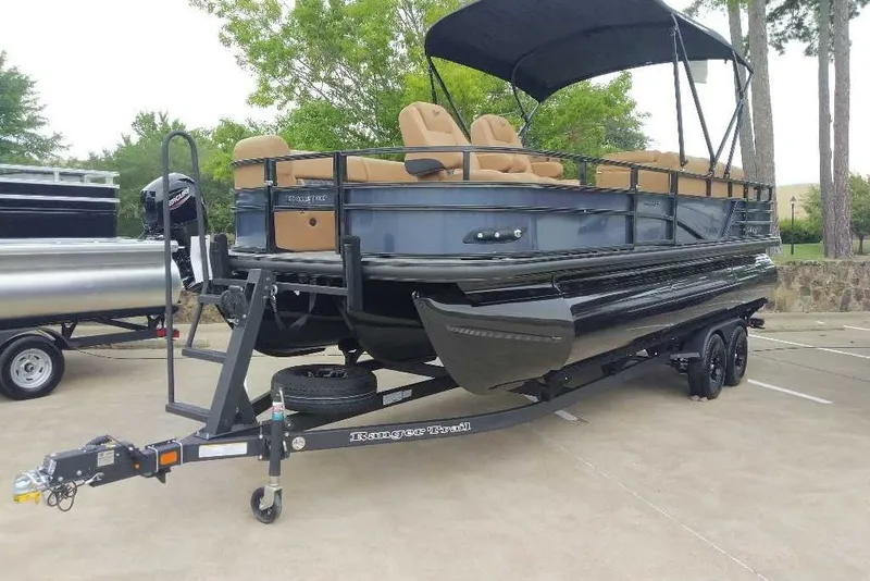 Slide: The Image of 2027 Ranger 223FC pontoon boat on trailer, featuring tan seating and black canopy. - 12
