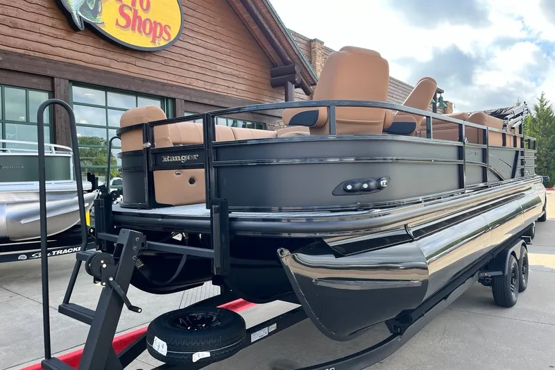 Slide: The Image of 2027 Ranger 223FC pontoon boat displayed outside a store, featuring sleek design and tan seating. - 10