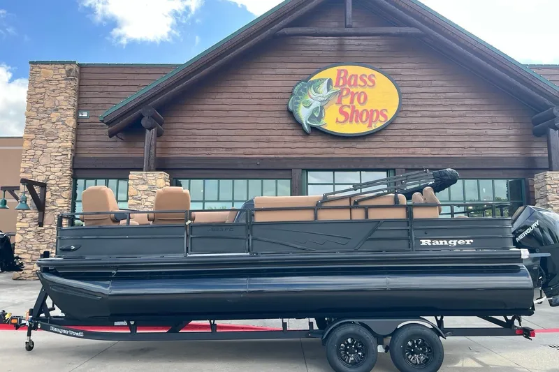 Slide: The Image of 2027 Ranger 223FC pontoon boat outside Bass Pro Shops, showcasing sleek design and Mercury engine. - 1