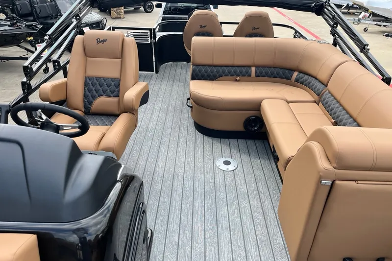 Slide: The Image of Luxurious interior of 2027 Ranger 223FC boat with tan leather seating and modern design. - 2