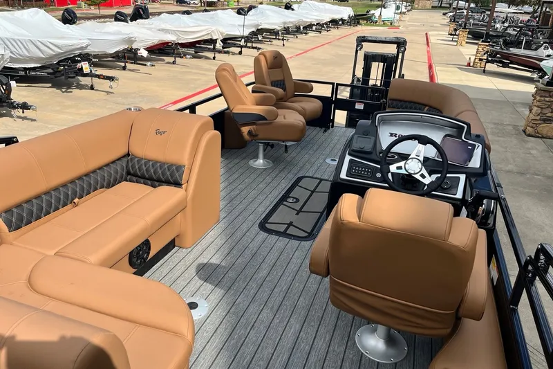 Slide: The Image of Luxurious 2027 Ranger 223FC boat interior with tan seating and modern dashboard. - 3