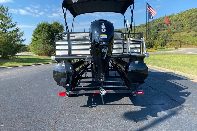 Slide: The Image of 2027 Ranger 220FC pontoon boat with 150 HP motor, parked on asphalt. - 6