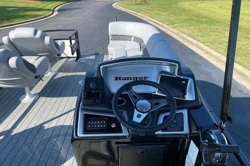 Slide: The Image of 2027 Ranger 220FC boat interior with steering wheel, seating, and control panel. - 3