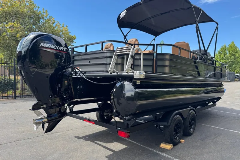 The Image of 2027 Ranger 220F pontoon boat with Mercury outboard engine on a trailer. - 0