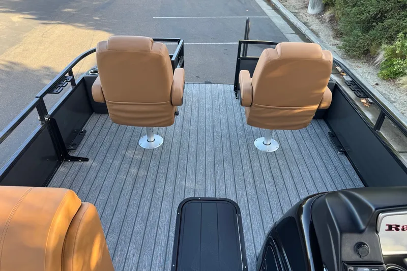 Slide: The Image of Ranger 223F 2027 boat interior with tan seats and gray flooring. - 13