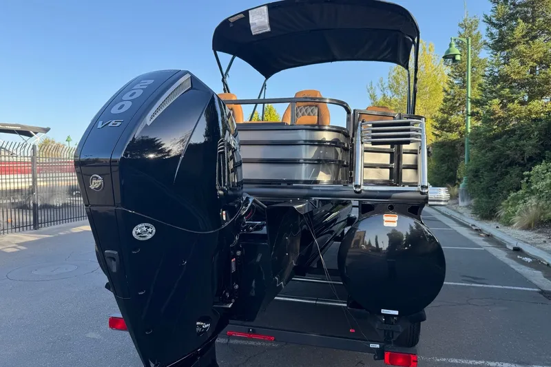 Slide: The Image of Ranger 223F 2027 boat with powerful 200 V6 engine, parked outdoors. - 7