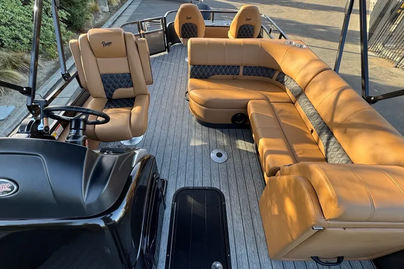 Slide: The Image of 2027 Ranger 223F boat interior with tan leather seating and modern steering console. - 9
