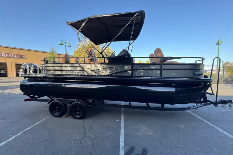Slide: The Image of 2027 Ranger 223F pontoon boat with canopy on trailer in parking lot. - 5
