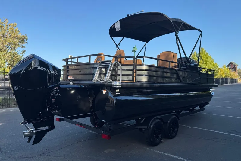 Slide: The Image of 2027 Ranger 223F pontoon boat with Mercury engine, parked on a trailer in a sunny lot. - 6