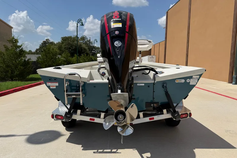 Slide: The Image of 2027 Ranger RB200 boat on trailer, rear view with outboard motor, parked outdoors. - 12