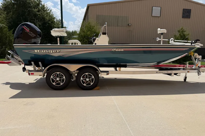 Slide: The Image of 2027 Ranger RB200 boat on trailer, parked outdoors, showcasing sleek design and modern features. - 4