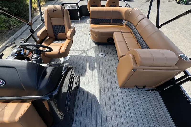 Slide: The Image of Luxurious interior of 2027 Ranger 220FC boat with tan leather seating and modern helm. - 13
