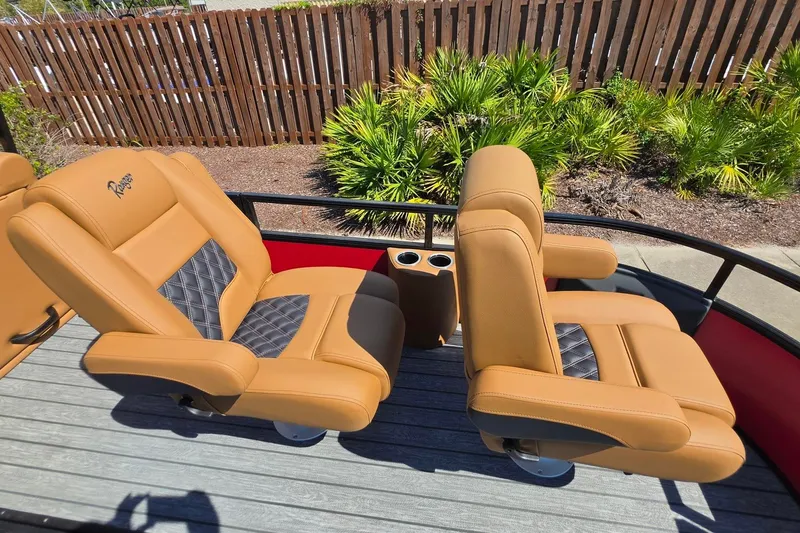 Slide: The Image of Luxurious tan seating on 2027 Ranger 223FC boat, featuring diamond-patterned accents and cup holders. - 22