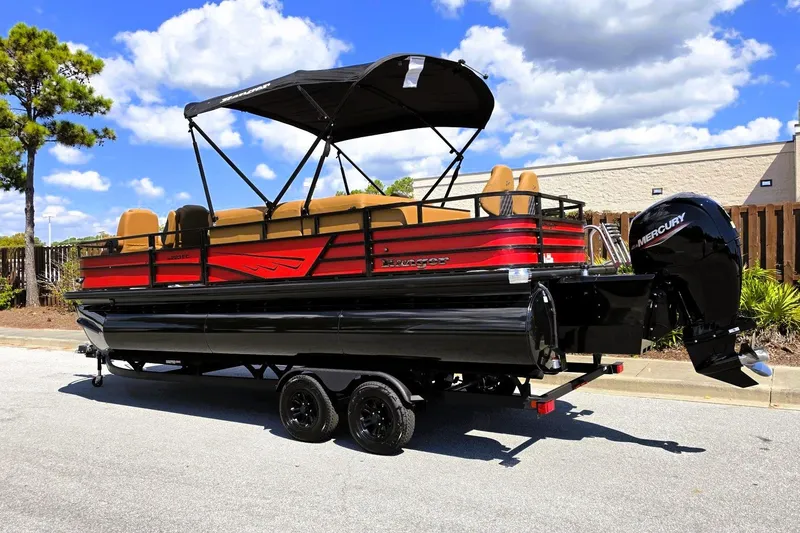 Slide: The Image of 2027 Ranger 223FC pontoon boat with Mercury engine on trailer, parked outdoors. - 13