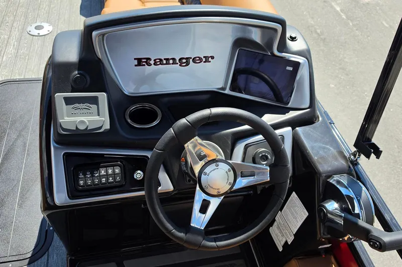 Slide: The Image of 2027 Ranger 223FC boat dashboard with steering wheel, controls, and display screen. - 16