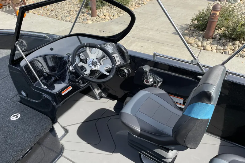 Slide: The Image of Interior view of a 2027 Nitro ZV19 Sport boat cockpit with steering wheel and seat. - 13