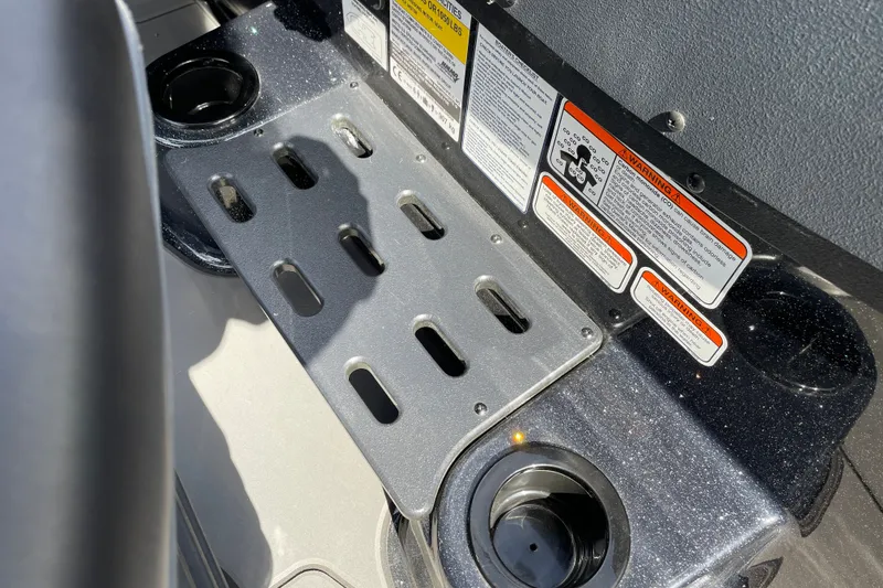 Slide: The Image of Interior of 2027 Nitro ZV19 Sport boat with safety labels and cup holders. - 19