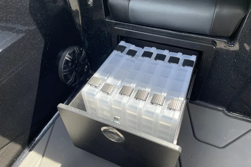 Slide: The Image of Storage compartment with tackle boxes in a 2027 Nitro ZV19 Sport boat. - 31