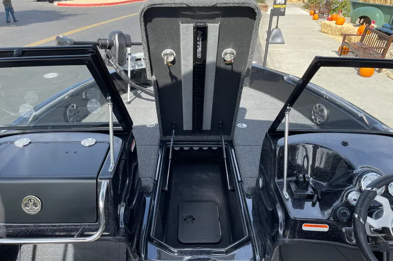 Slide: The Image of 2027 Nitro ZV19 Sport boat interior with open storage compartments and steering console. - 21