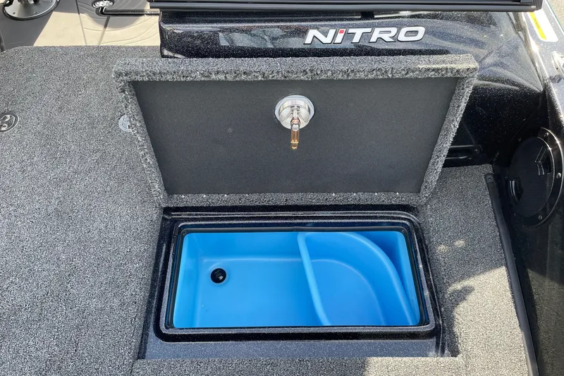 Slide: The Image of 2027 Nitro ZV19 Sport boat livewell with open lid, showcasing blue interior. - 23