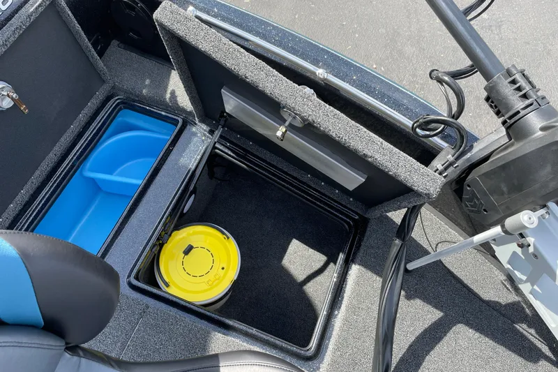 Slide: The Image of Interior storage compartment of 2027 Nitro ZV19 Sport boat with blue and yellow containers. - 25