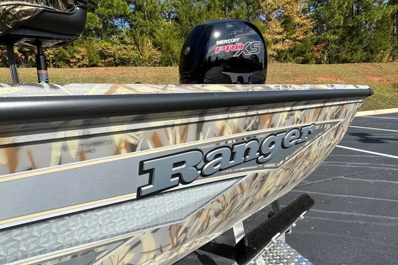 Slide: The Image of 2027 Ranger RB200 boat with camo design and Mercury Pro XS engine in a parking lot. - 7