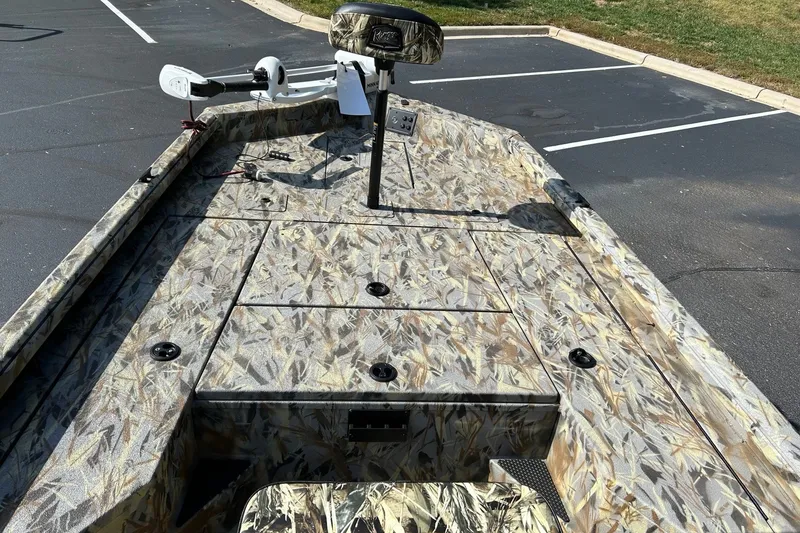 Slide: The Image of 2027 Ranger RB200 boat with camouflage design in a parking lot. - 12