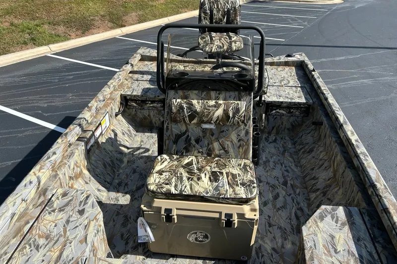 Slide: The Image of 2027 Ranger RB200 boat with camouflage interior, parked in a lot. - 9