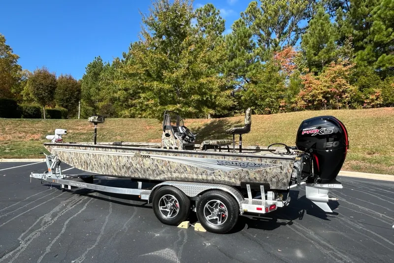 Slide: The Image of 2027 Ranger RB200 boat with camouflage design on a trailer, parked outdoors. - 4