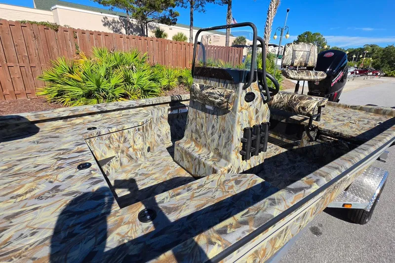 Slide: The Image of 2027 Ranger RB190 boat with camouflage design, parked outdoors on a sunny day. - 20