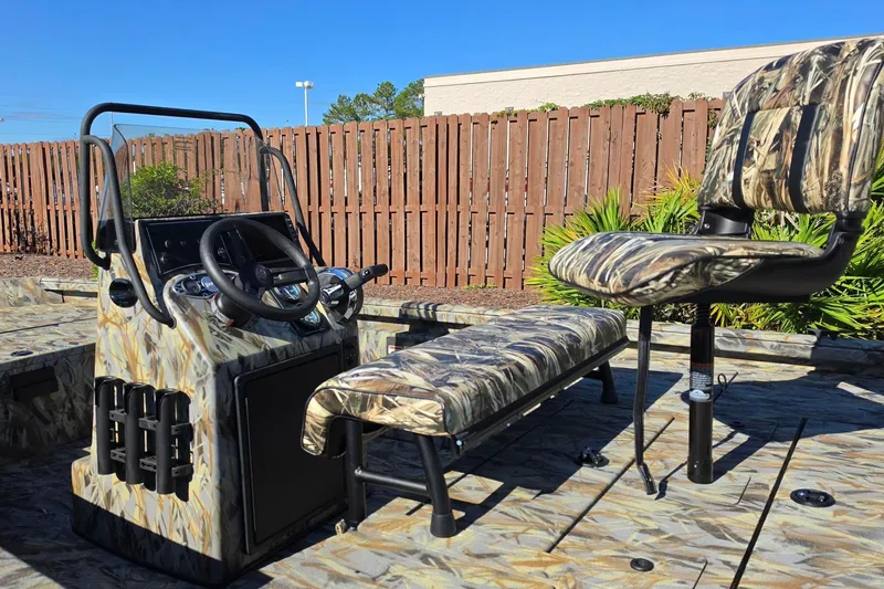 Slide: The Image of 2027 Ranger RB190 boat interior with camo seats and steering console. - 18