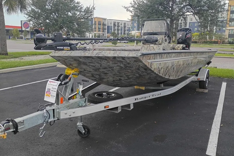 Slide: The Image of 2027 Ranger RB190 boat on trailer, camo design, parked in lot. - 1