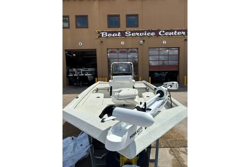 Slide: The Image of 2027 Ranger RB190 boat at service center, featuring Minn Kota trolling motor. - 14