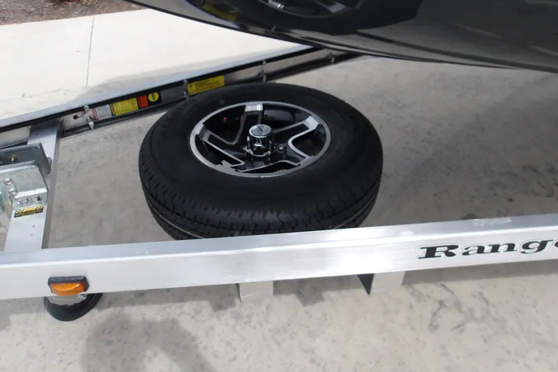 Slide: The Image of Ranger RB200 trailer with spare tire, 2027 model, on concrete surface. - 14
