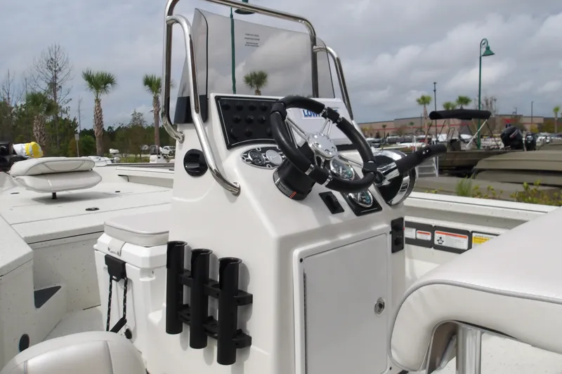 Slide: The Image of 2027 Ranger RB200 boat console with steering wheel and controls, set against a marina backdrop. - 17