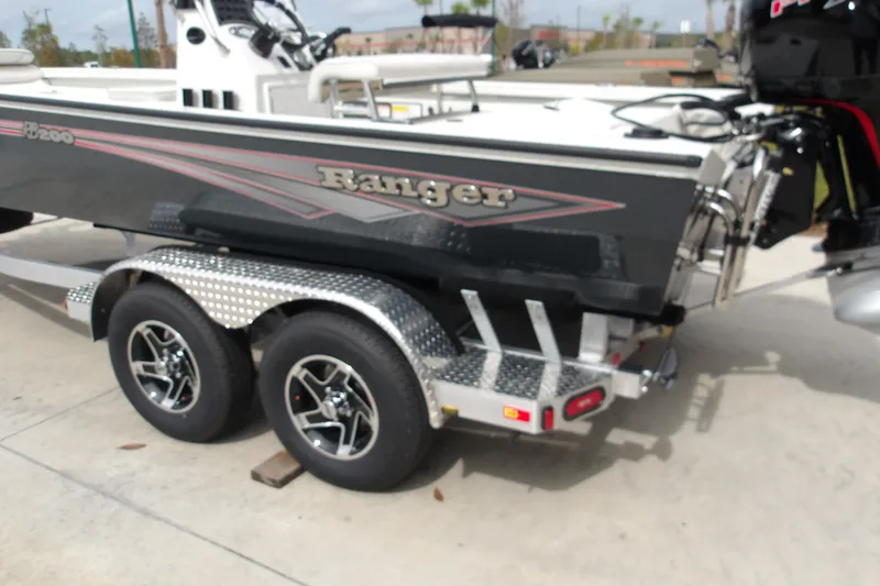 Slide: The Image of 2027 Ranger RB200 boat on a dual-axle trailer, parked outdoors. - 2
