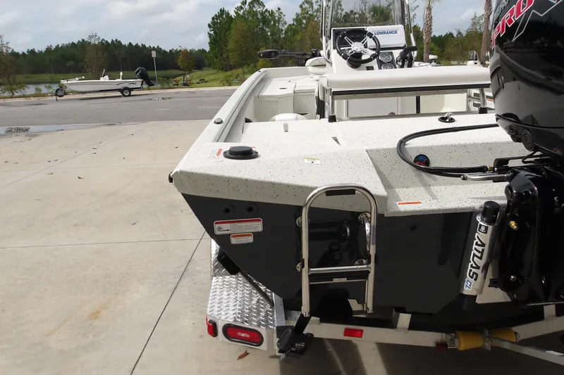 Slide: The Image of Ranger RB200 2027 boat with motor and ladder, parked near a lake. - 4