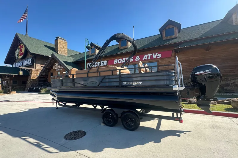 The Image of 2027 Ranger 220F boat with Mercury engine outside a store, sunny day. - 0