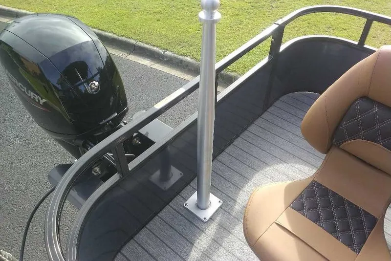 Slide: The Image of Ranger 220FC boat interior with Mercury engine, featuring tan and black seating, 2027 model. - 6