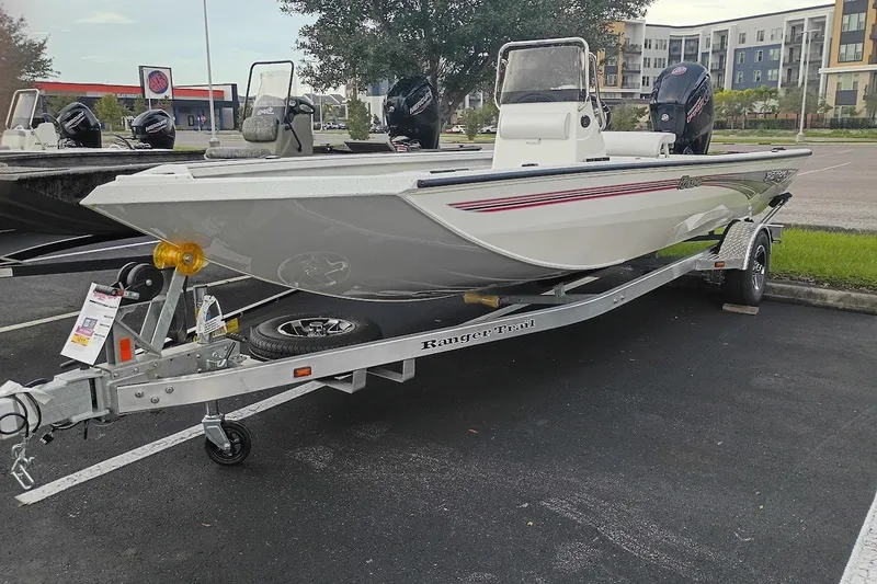 Slide: The Image of 2027 Ranger RB190 boat on trailer in parking lot, featuring sleek design and modern outboard motor. - 1