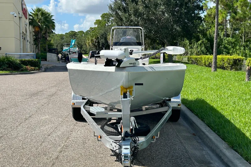 Slide: The Image of 2027 Ranger RB200 boat on trailer, parked on a sunny street with lush greenery. - 3