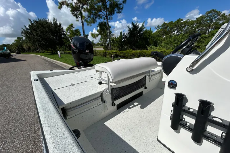 Slide: The Image of 2027 Ranger RB200 boat interior with seating and motor, parked on a sunny day. - 10