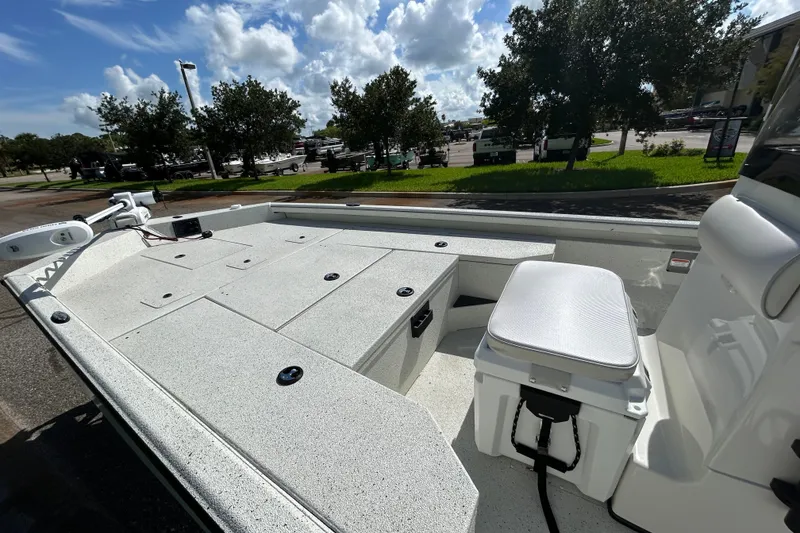 Slide: The Image of 2027 Ranger RB200 boat interior with seating and storage, parked outdoors under a sunny sky. - 12
