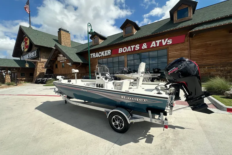The Image of 2027 Ranger RB190 boat displayed outside a Tracker Boats & ATVs store. - 0