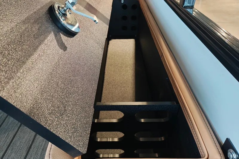 Slide: The Image of Open storage compartment in 2027 Ranger 220FC boat, featuring a secure latch mechanism. - 55