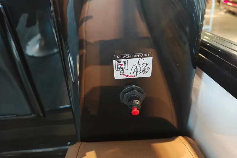 Slide: The Image of Close-up of a 2027 Ranger 220FC lanyard attachment point with safety instructions. - 34