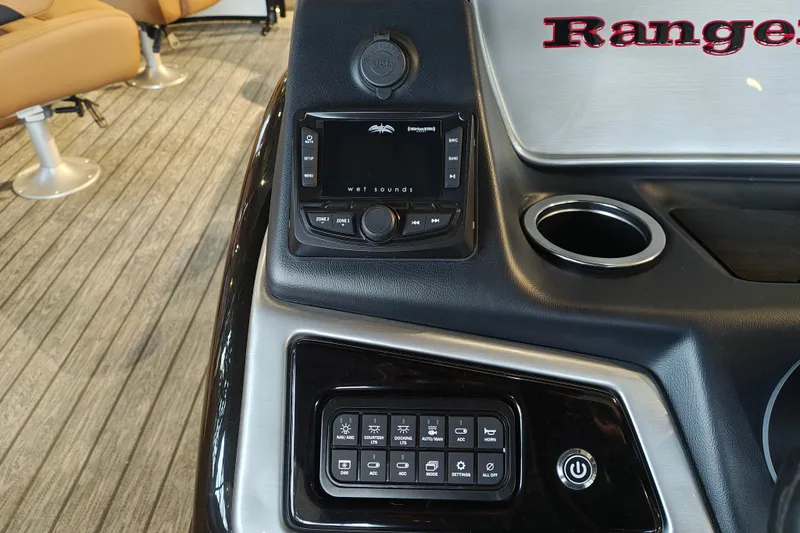 Slide: The Image of Control panel of 2027 Ranger 220FC boat with audio system and cup holder. - 27
