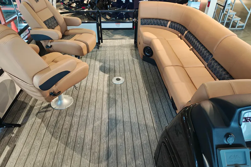Slide: The Image of 2027 Ranger 220FC boat interior with tan seating and wood-patterned flooring. - 61